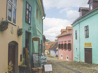 The streets of Sighișoara, Romania, are adorned with charming houses painted in a vibrant spectrum of colors, adding to the town's medieval allure