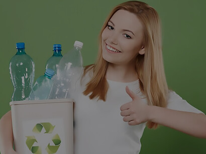 A woman holds pet bottles for recycling