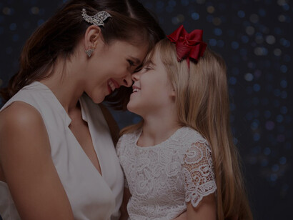 A mother and daughter joyfully hug, reflecting the warmth of maternal love