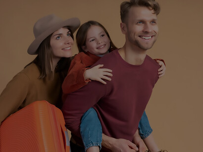 Prepare for your next getaway with a delightful image of a young family of three, posing together in anticipation of their upcoming travel vacation