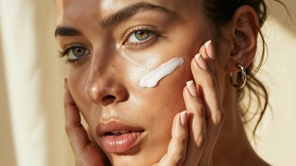 A woman incorporating skincare into her morning routine, representing the first line of defense against premature skin aging